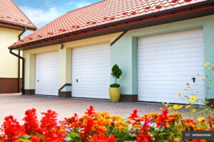 A beautifully designed garage door with a sleek, modern aesthetic, featuring a combination of frosted glass panels and dark steel frames that complement the contemporary exterior of a home. The natural light filtering through the frosted glass adds a touch of elegance and sophistication to the overall architecture.