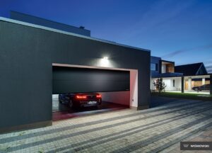 An elegant garage door featuring a sleek and modern design with a smooth, silk line finish in a sophisticated RAL 7035 light grey color, perfect for enhancing the curb appeal of contemporary homes.